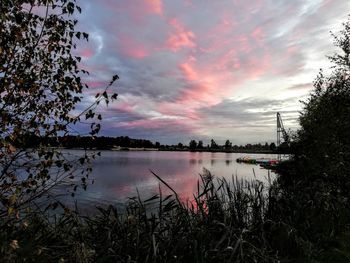 Scenic view of lake against sky at sunset