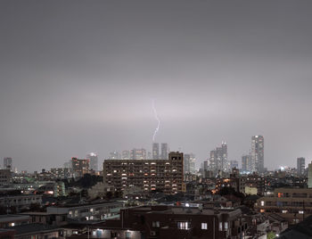 Lightning over cityscape at night