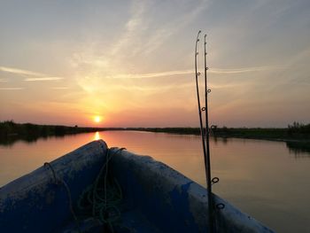 Blue boat floating on danube river at sunrise