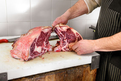 Butcher preparing food on cutting board