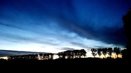 Scenic view of landscape against sky at dusk