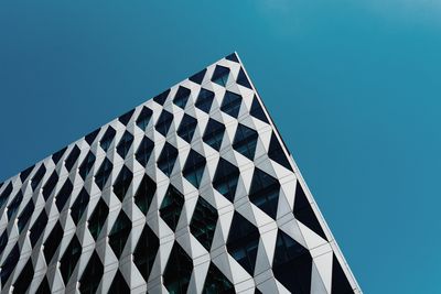 Low angle view of modern building against clear blue sky