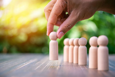 Cropped hand of person with toy blocks on table