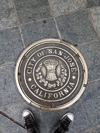 Low section of person standing on tiled floor