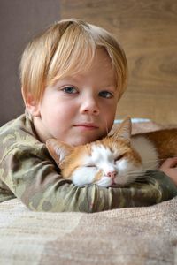 Portrait of a child aged four years old whit sleeping red cat