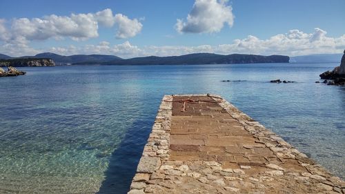 View of calm sea against cloudy sky