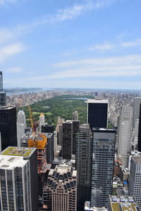 Aerial view of buildings in city against sky