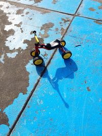 Close-up of a kids bike and blue shadow