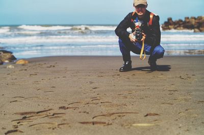 Full length of boy playing at beach