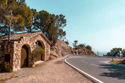 Sharp street turn on the coastal road. viewpoint with stone wall building