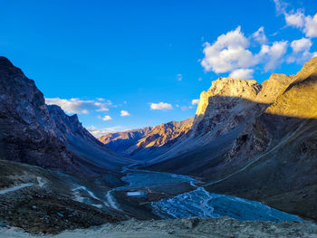 Scenic view of mountains against blue sky