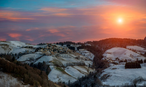 Scenic view of snowcapped mountains against sky during sunset