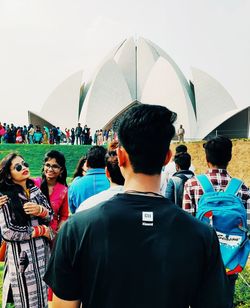 Rear view of people standing outdoors