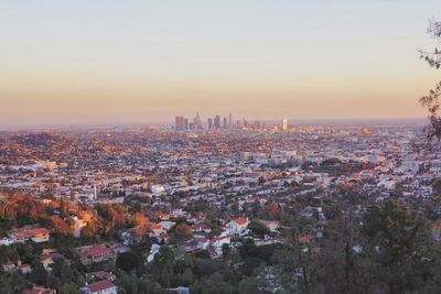 High angle view of buildings in city during sunset