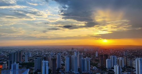 Aerial view of modern buildings against sky during sunset