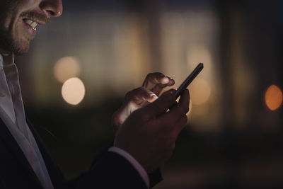 Close-up of businessman text messaging