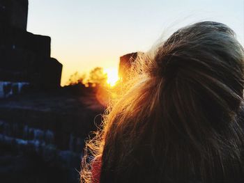 Close-up portrait of woman against sky during sunset