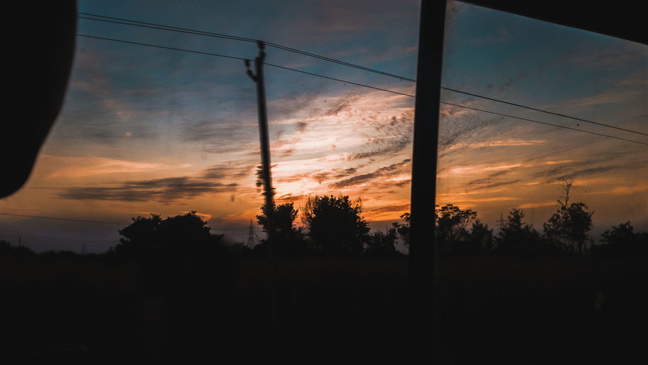 SILHOUETTE TREES AND ELECTRICITY PYLON AGAINST SKY AT SUNSET