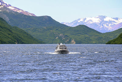 Scenic view of sea and mountains against sky