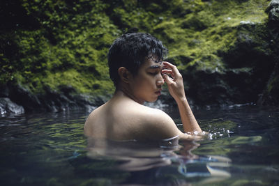 Close-up of man swimming in lake