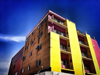 Low angle view of building against blue sky