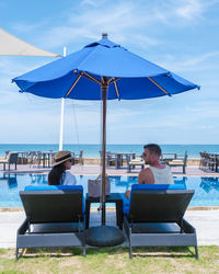 Lounge chairs and tables at beach