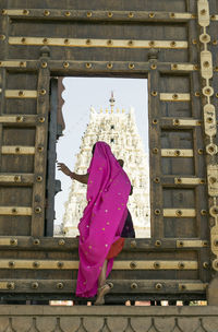 Rear view of woman walking in temple