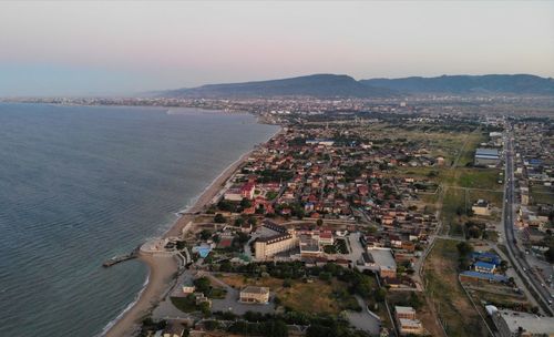 High angle view of buildings by sea against sky