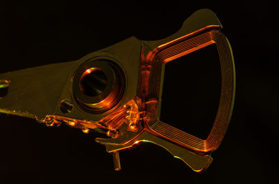 Close-up of illuminated lighting equipment against black background