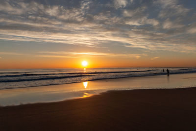 Scenic view of beach against sky during sunset