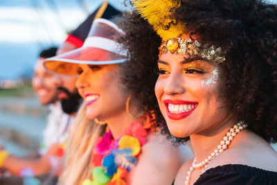 Smiling woman looking away while enjoying with friends