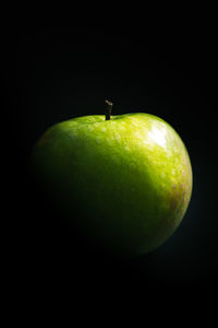 Close-up of apple against black background