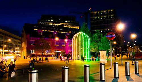 Illuminated city against sky at night