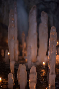 Close-up of lit candles in temple