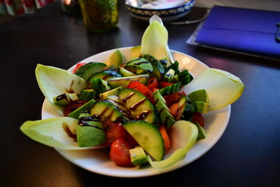 High angle view of chopped fruits in plate on table