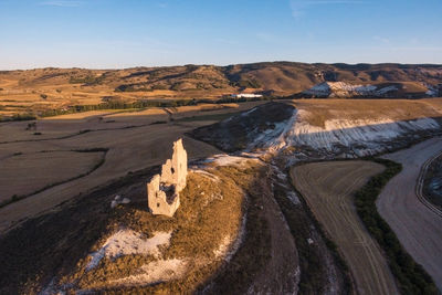 Aerial view of built structure on landscape against sky