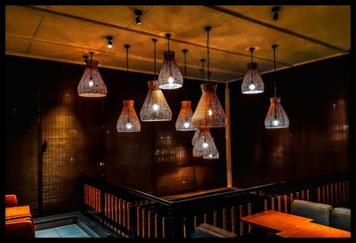 Illuminated pendant lights hanging in restaurant