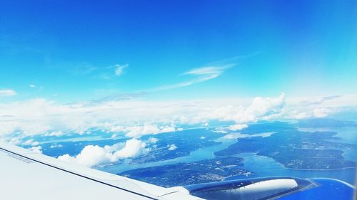 Cropped image of airplane flying over sea