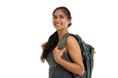 Portrait of smiling young woman against white background