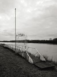 Pier over lake against sky