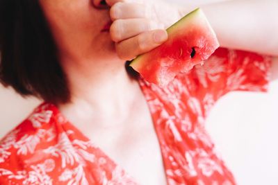 Close-up of woman hand holding red leaf