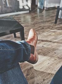 Low section of man standing on floor at home