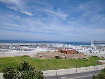 High angle view of buildings and sea against sky