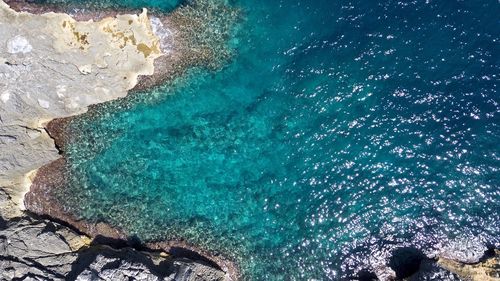 High angle view of rocks by sea