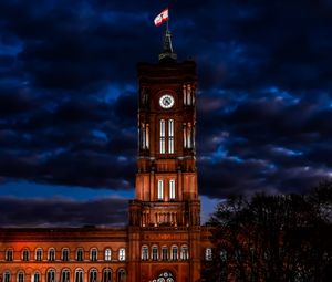 Low angle view of clock tower against sky at night