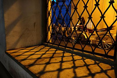 Shadow of fence on building