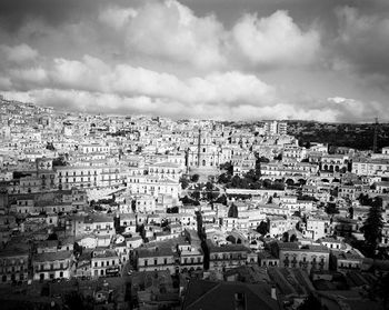 Cityscape against cloudy sky