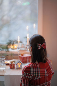 Portrait of young woman sitting on table