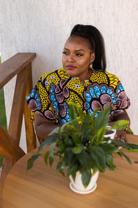 Young woman sitting on table