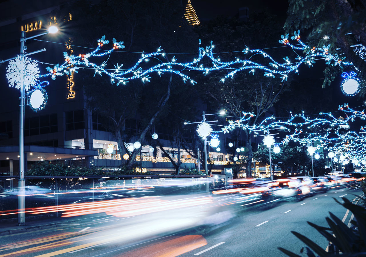 ILLUMINATED LIGHT TRAILS ON ROAD AT NIGHT